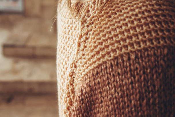 Woman's shoulder close up. Woman in a cozy beige sweater spends time outdoors. Lifestyle portrait of female - Photo, Image
