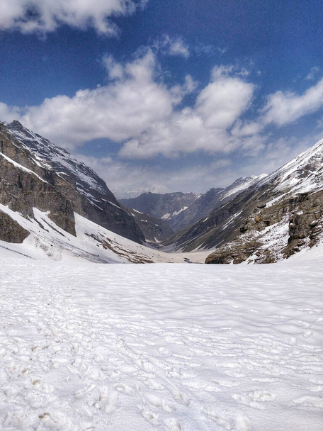 Epic panoramic view of Kullu Valley under snow in the month of June from top of Indian Himalayan Mountain peak on a Humpta pass Trek near Manali. - Photo, Image