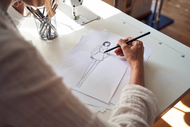 Couturier drawing sketches of clothing - Foto, Imagem
