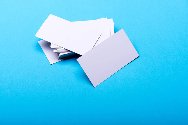 Business cards stack on cyan blue background. - Фото, зображення