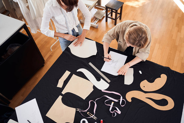 Designers making patterns on the black fabric - Fotó, kép