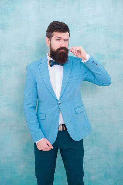 Stylist fashion expert. Suit style. Fashion trends for groom. Groom bearded hipster man wear light blue tuxedo and bow tie. Wedding day. Stylish groom. Statement with his stunning crisp suit jacket - 写真・画像