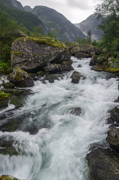 Wild Bondhuselva creek in the rocky Bondhusdalen valley during a rainy summer day, Norway, Scandinavia - 写真・画像