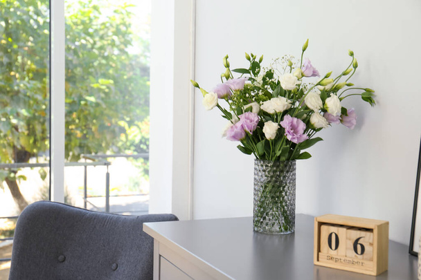 Bouquet of beautiful Eustoma flowers on chest of drawers in room. Space for text - Fotografie, Obrázek