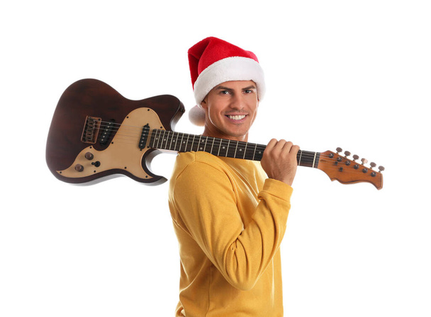 Man in Santa hat with electric guitar on white background. Christmas music - Foto, Bild
