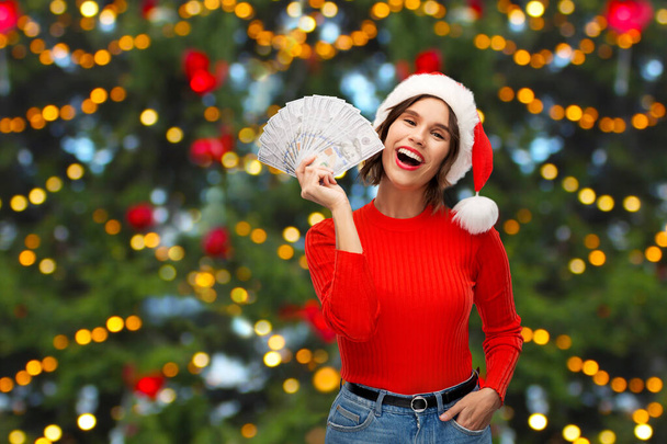 happy woman in santa hat with money on christmas - Zdjęcie, obraz