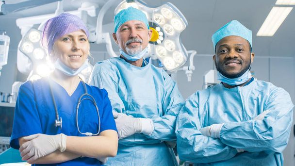 Diverse Team of Professional surgeon, Assistant and Nurse Standing Proudly with Crossed Arms in the Real Modern Hospital with Authentic Equipment.  - Photo, Image