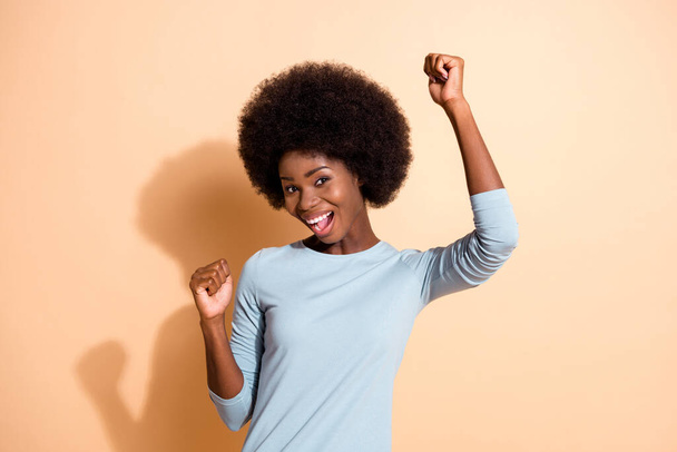 Photo portrait of african american woman dancing smiling laughing isolated on pastel beige colored background - Photo, image