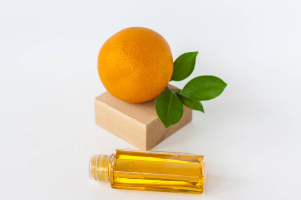 Orange oil for the body. Orange on a white background. Organic SPA cosmetics with herbal ingredients. Cosmetology.  - Фото, изображение