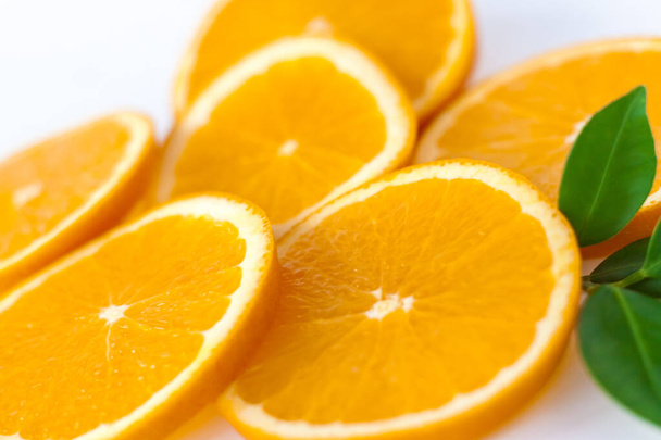 Cut orange on a white background. Natural orange fruit with cut slices. Vitamin C. Healthy citrus fruit. - Foto, imagen