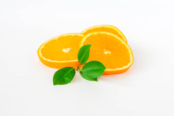 Cut orange on a white background. Natural orange fruit with cut slices. Vitamin C. Healthy citrus fruit.  - Photo, Image