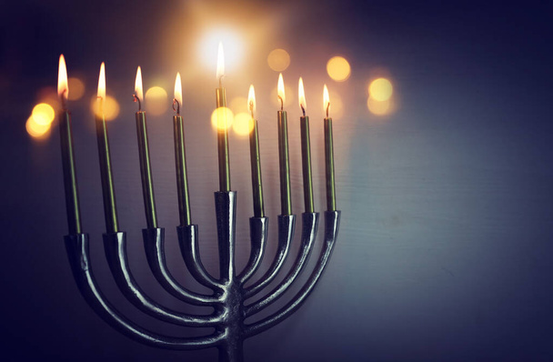 Religion image of jewish holiday Hanukkah background with menorah (traditional candelabra) and candles - Fotó, kép