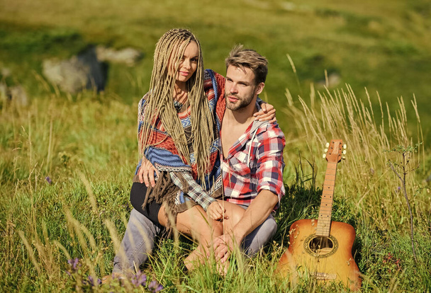 Romantic hike. Family hike. Boyfriend and girlfriend with guitar in mountains. Enjoying each other. Summer hike. Breathtaking feelings. Hiking romance. Couple happy cuddling nature background - Foto, immagini