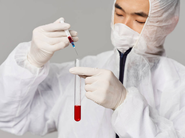 Male scientist laboratory developing drugs gray background - Фото, изображение