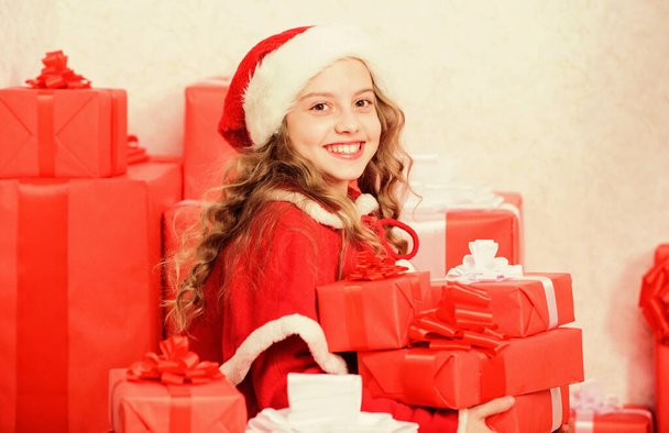 Unpacking christmas gift. Kid excited about opening christmas present. Girl celebrate christmas. Kid helping santa. New year holiday tradition. Little santas helper concept. Explore christmas gifts - Фото, зображення
