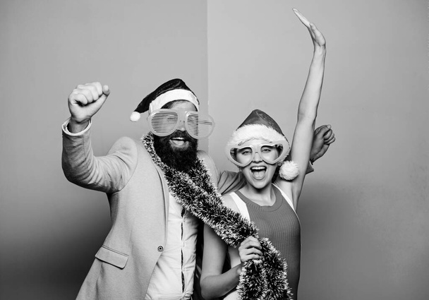 Winter corporate party. Office christmas party. Happy man and woman wear santa hats and funny sunglasses. Manager tinsel celebrate new year. Christmas party office. Corporate holiday party ideas - Zdjęcie, obraz