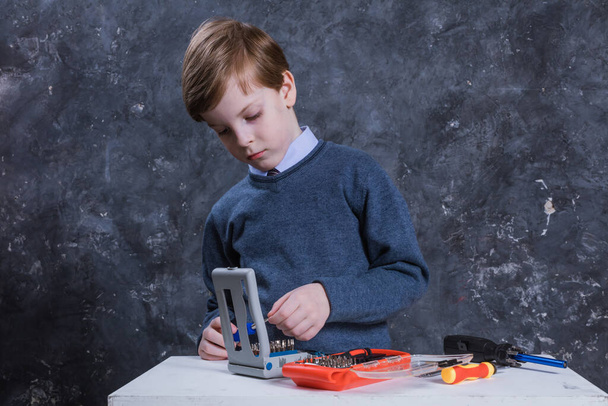 Cute boy with working tools studio portrait. - Foto, imagen
