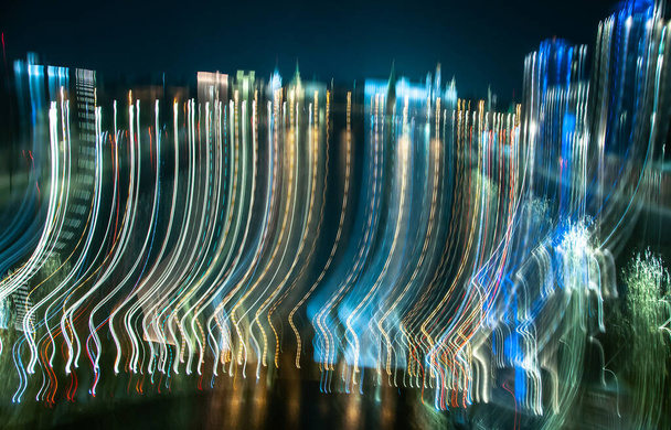 Neon bright glowing lines of the night city from a blurred frame - Foto, Imagen
