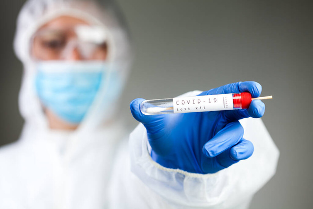 COVID-19 virus disease self swab test sample kit, medical laboratory scientist holding a test tube with throat or nose swab viral specimen collection equipment, Coronavirus health check up concept - Foto, Imagen