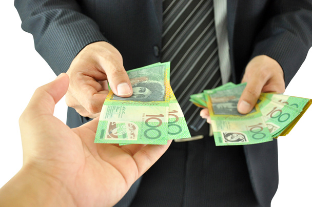 Hand erhält Geld - australischer Dollar - von einem Geschäftsmann - Foto, Bild