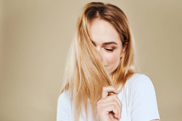 Cheerful blonde gesturing with her hands studio beige background - Photo, Image