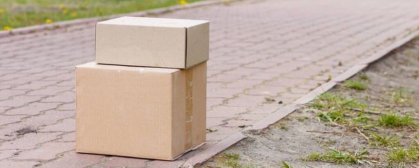Parcel cardboard box in front door.Door to Door delivery of good merchandises while the quarantine,Delivered outside the door, e-commerce purchase during covid-19 lock down,Social Distance concept. - Photo, Image