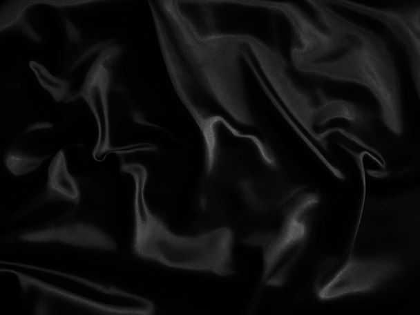 Zwarte gerimpelde stof achtergrond.. Vloeibare golvende vorm. - Foto, afbeelding