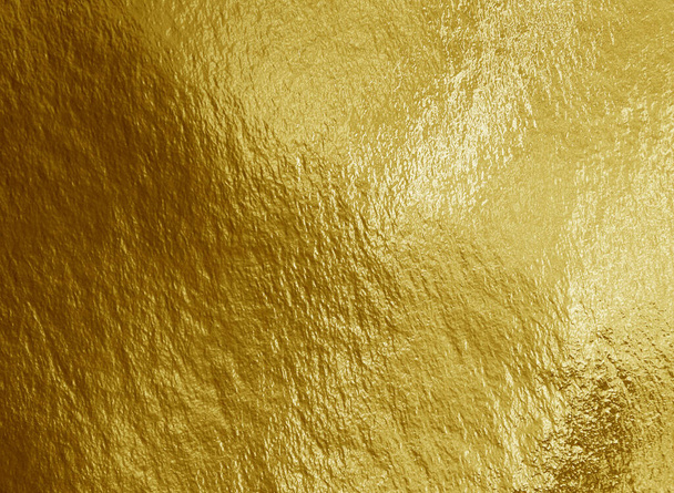 Gold foil background with highlights and uneven texture - Photo, Image