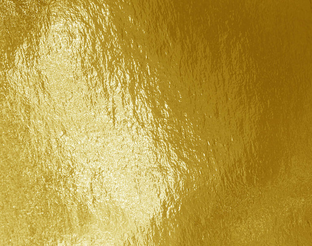 Gold foil background with highlights and uneven texture - Photo, Image