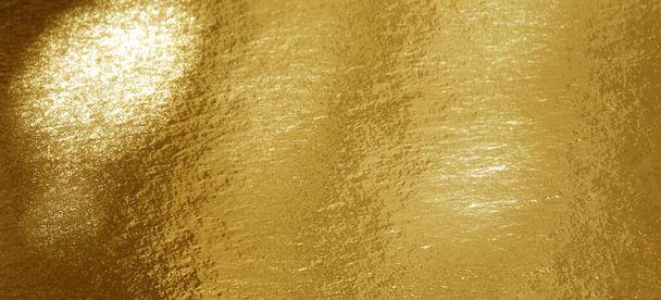 Gold shiny foil with highlights and uneven texture - Photo, Image