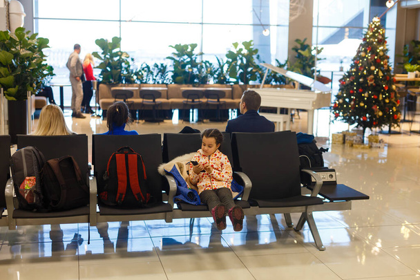 Little girl sitting in airport terminal waiting for flight - Photo, Image