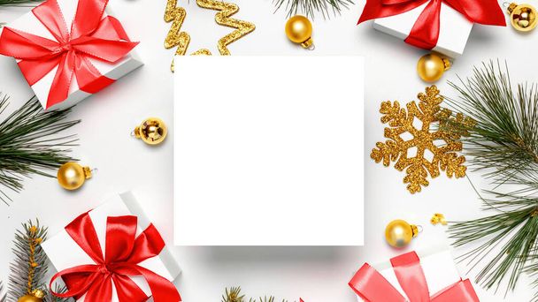 Happy xmas. White gift box with red ribbon, New Year balls and Christmas tree on white background for greeting card. Copy space. Winter holidays, New Year. - Photo, Image