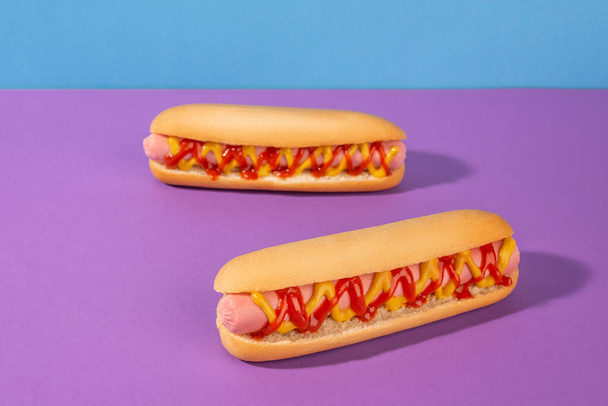 Two fresh hot dogs with ketchup and mustard - Foto, afbeelding