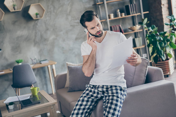 Portrait of his he nice attractive serious professional brunet guy working remotely calling partner discussing document at modern loft brick industrial interior house flat apartment - Foto, Imagem