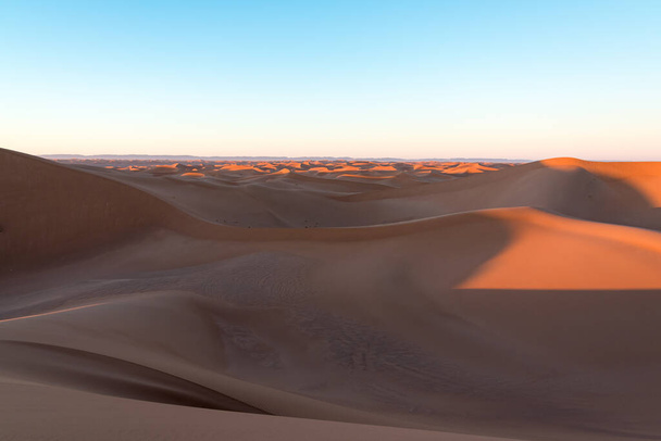 Huge desert dunes of Erg Chigaga, at the gates of the Sahara, al amanecer. Morocco. Concept of travel and adventure. - Photo, Image