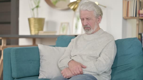 Cansado anciano mayor teniendo dolor de espalda en sofá - Imágenes, Vídeo