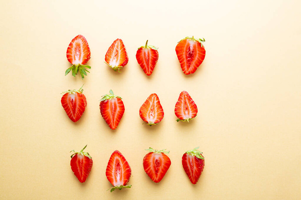 Overhead view of strawberry  on golden surface - Foto, afbeelding