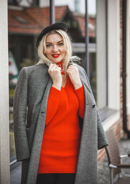 Woman at city, plus size blonde nice woman outdoor portrait. Pretty nice lady in fashionable warm outfit, lifestyle, shopping time, woman at walk - Photo, image