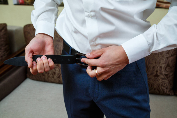 A man puts on a men's suit on the day of the wedding - Photo, Image