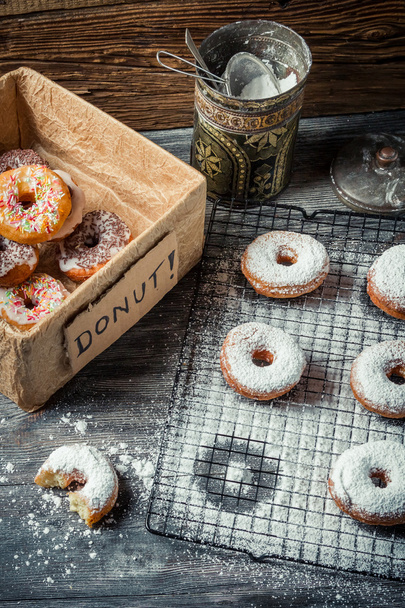 Tasting sweet donuts with icing sugar - Фото, зображення