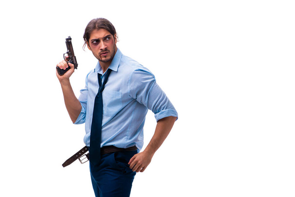 Empleado joven desesperado sosteniendo pistola - Foto, Imagen