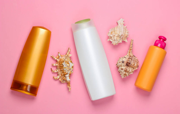 Bottles of shampoo with minerals and seashells on a pink background. Hair care. Top view. Flat lay - Photo, Image