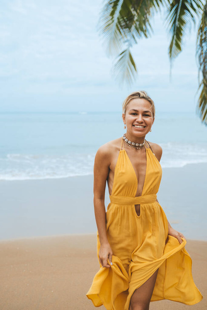 Happy woman walking on sandy beach in Thailand - 写真・画像