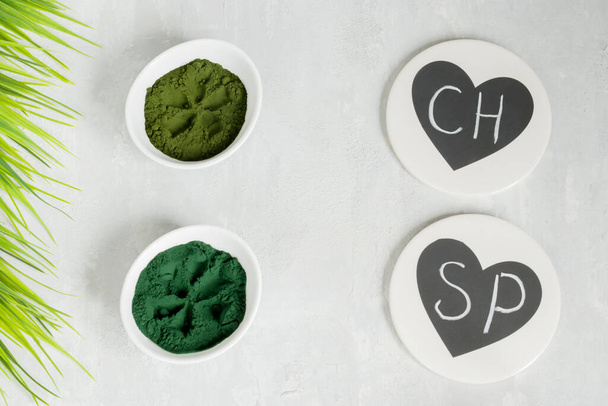 Chlorella and spirulina powder on a light background. Green superfood detox for the vegetarian diet. Chalk lettering. Healthy lifestyle concept. Copy space - Photo, Image