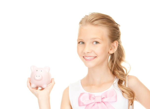 Lovely teenage girl with piggy bank - Fotó, kép