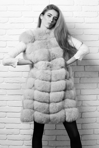 fashionable sexy girl in fur on brick wall studio background - Photo, Image