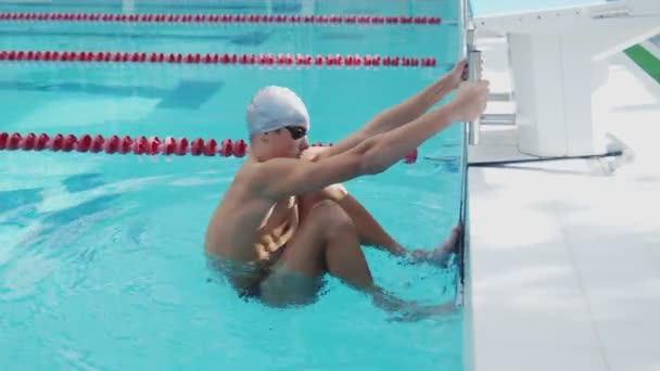 Professional swimmer pushes off and floats in the pool - Footage, Video