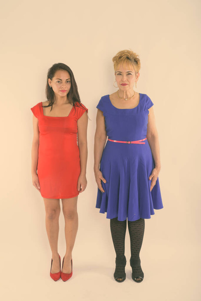 Studio shot of senior Asian woman and young beautiful woman together against white background - Foto, afbeelding