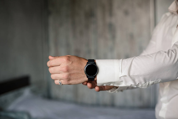 男性エレガントなビジネスマンのボタン彼は白いドレスシャツを着ている彼の手に時計 - 写真・画像