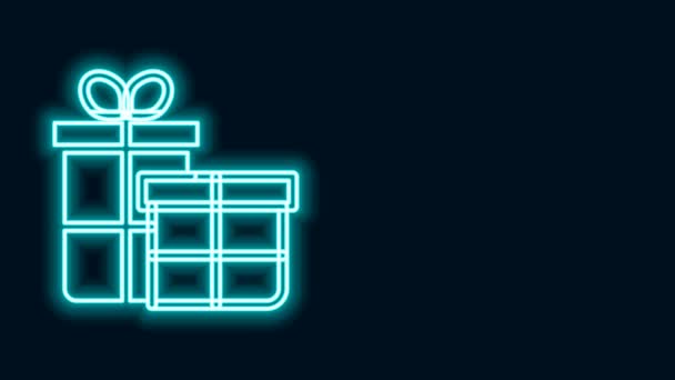 Ragyogó neon vonal Ajándék doboz ikon elszigetelt fekete háttér. Boldog karácsonyt és boldog új évet! 4K Videó mozgás grafikus animáció - Felvétel, videó